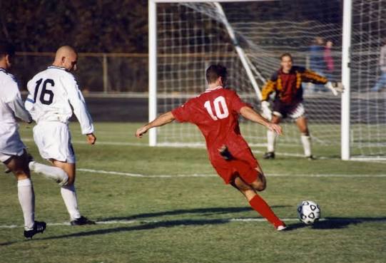 soccer-player-with-red-jersey-shooting-a-goal